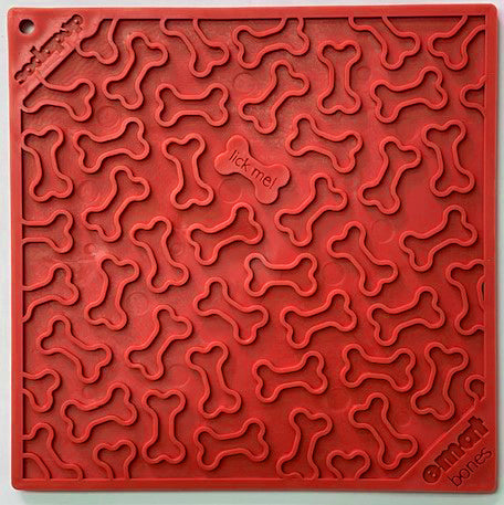 Red lick mat with bone shapes on it