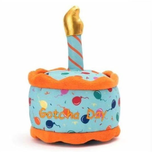 Cupcake shaped plush dog toy that says Gotcha Day.  It is light blue with orange trim and bright colored balloons