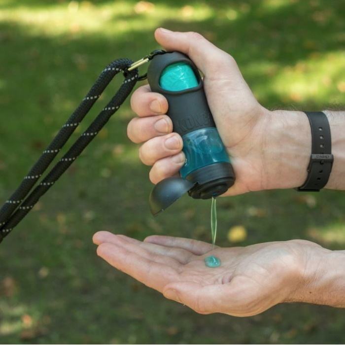 A poop bag dispenser with a container to add hand sanitizer