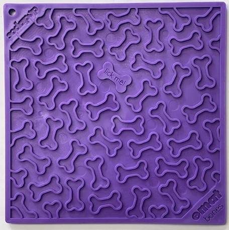 Purple lick mat with bone shapes on it